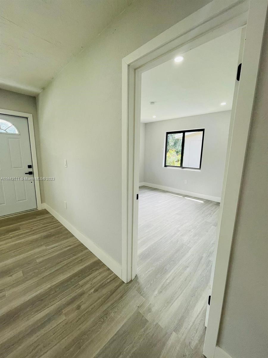 2521 Northwest 121st Street Miami, FL 33167 - Photo 25 of 43 a view of a hallway with wooden floor