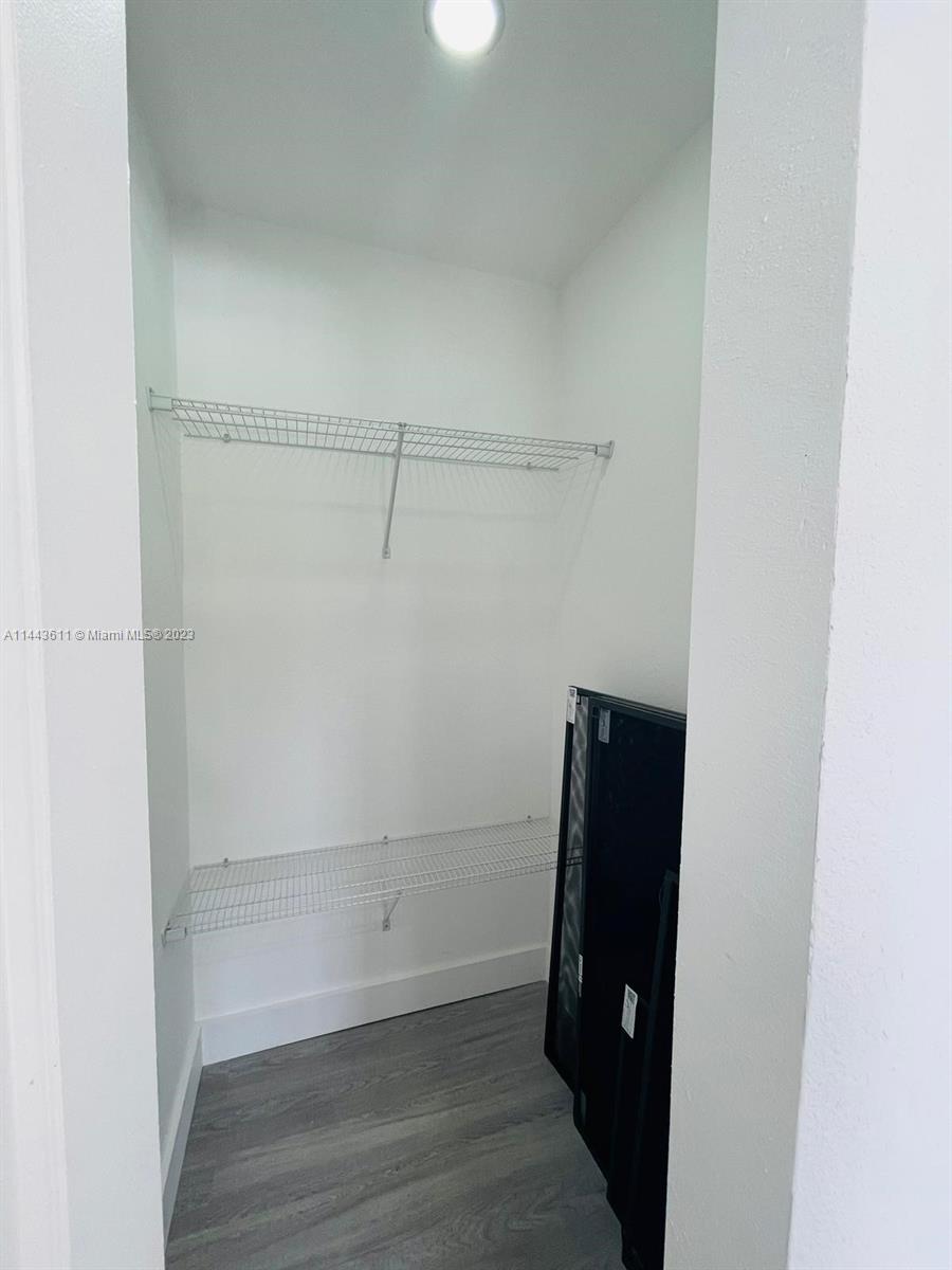 2521 Northwest 121st Street Miami, FL 33167 - Photo 27 of 43 a view of walk in closet with wooden floor