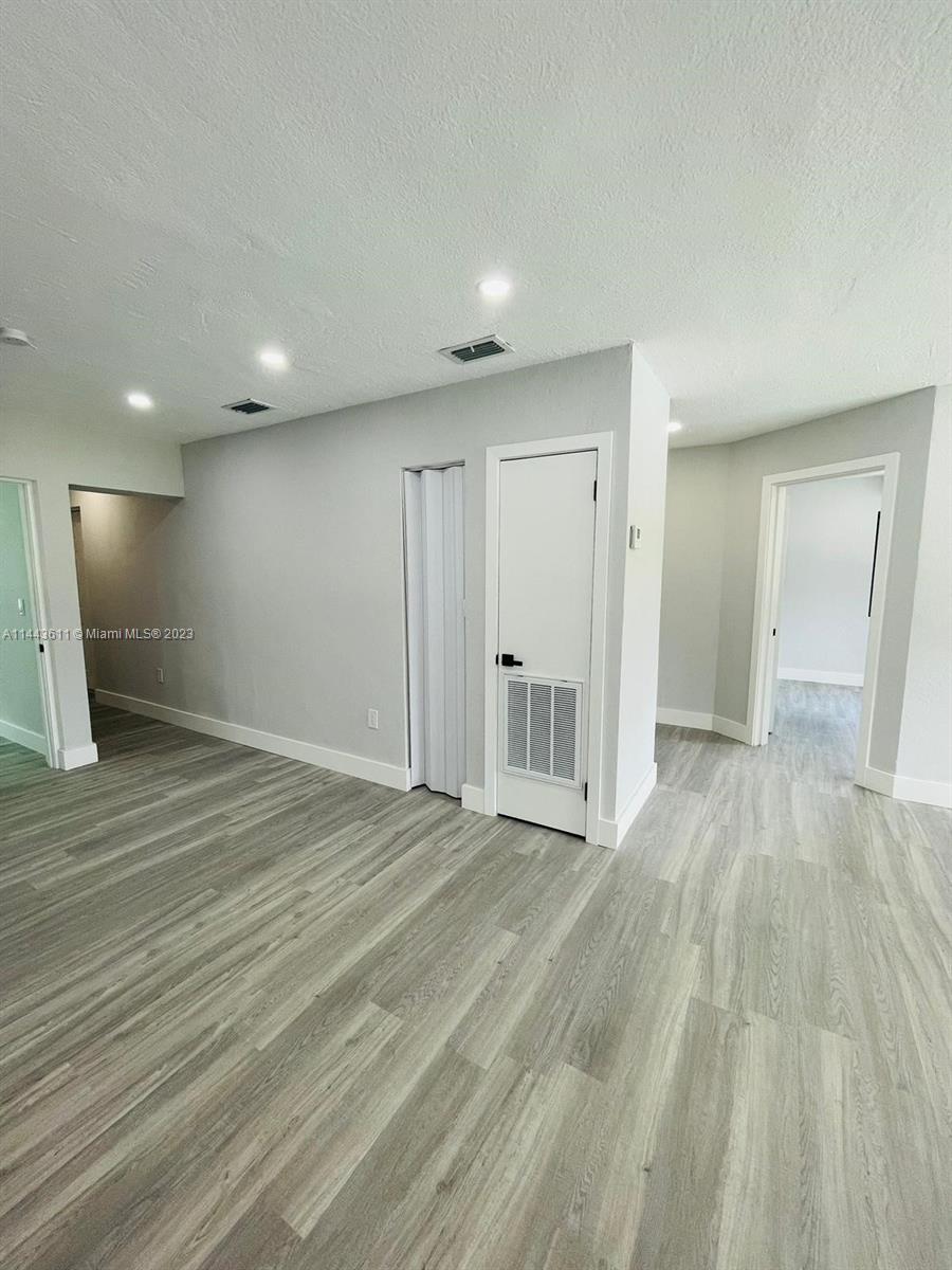2521 Northwest 121st Street Miami, FL 33167 - Photo 28 of 43 a view of an empty room with wooden floor