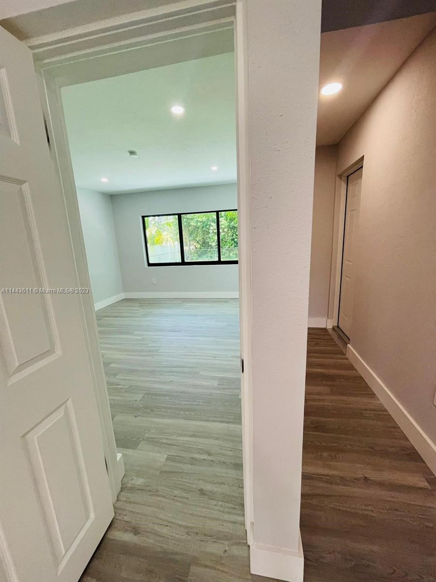 2521 Northwest 121st Street Miami, FL 33167 - Photo 29 of 43 a view of a hallway with wooden floor and staircase