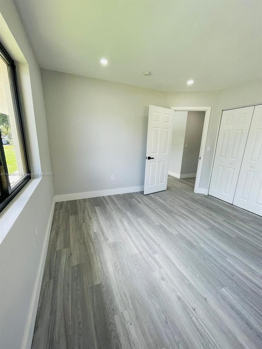 2521 Northwest 121st Street Miami, FL 33167 - Photo 32 of 43 wooden floor in an empty room with a window
