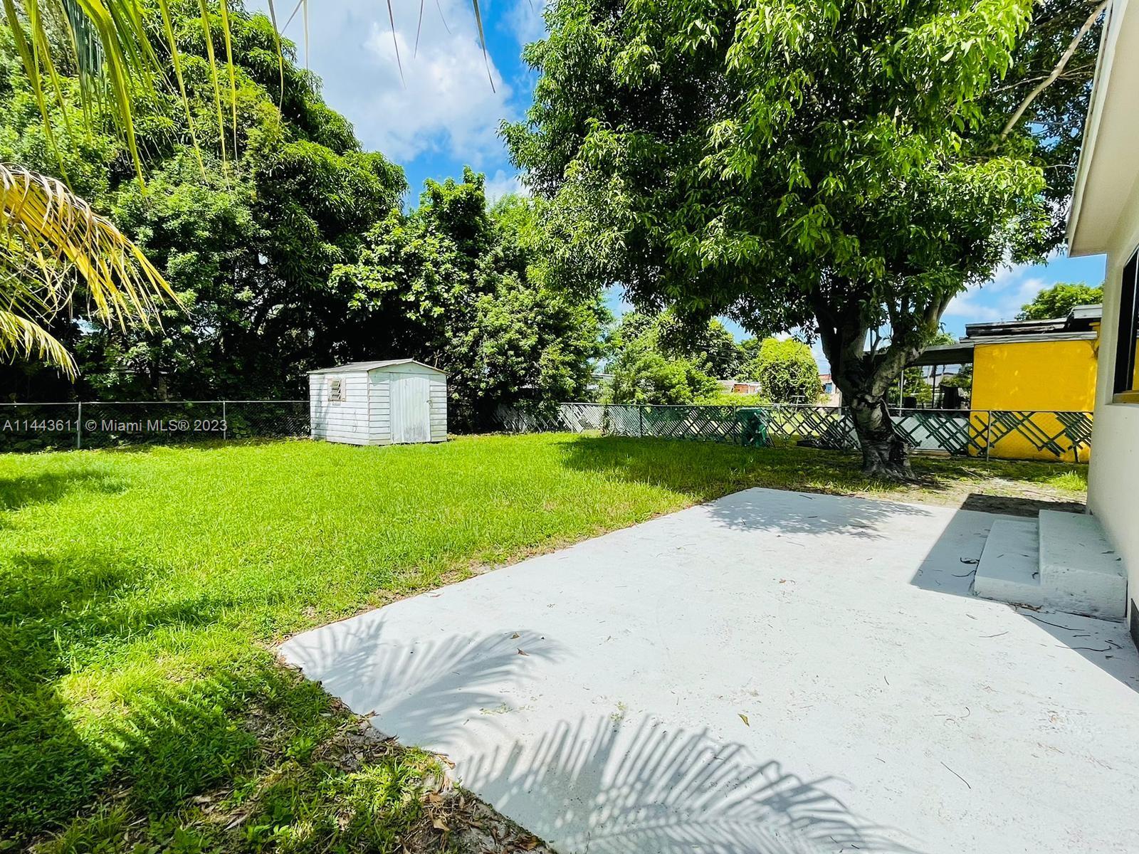 2521 Northwest 121st Street Miami, FL 33167 - Photo 35 of 43 a view of a backyard with a garden and trees