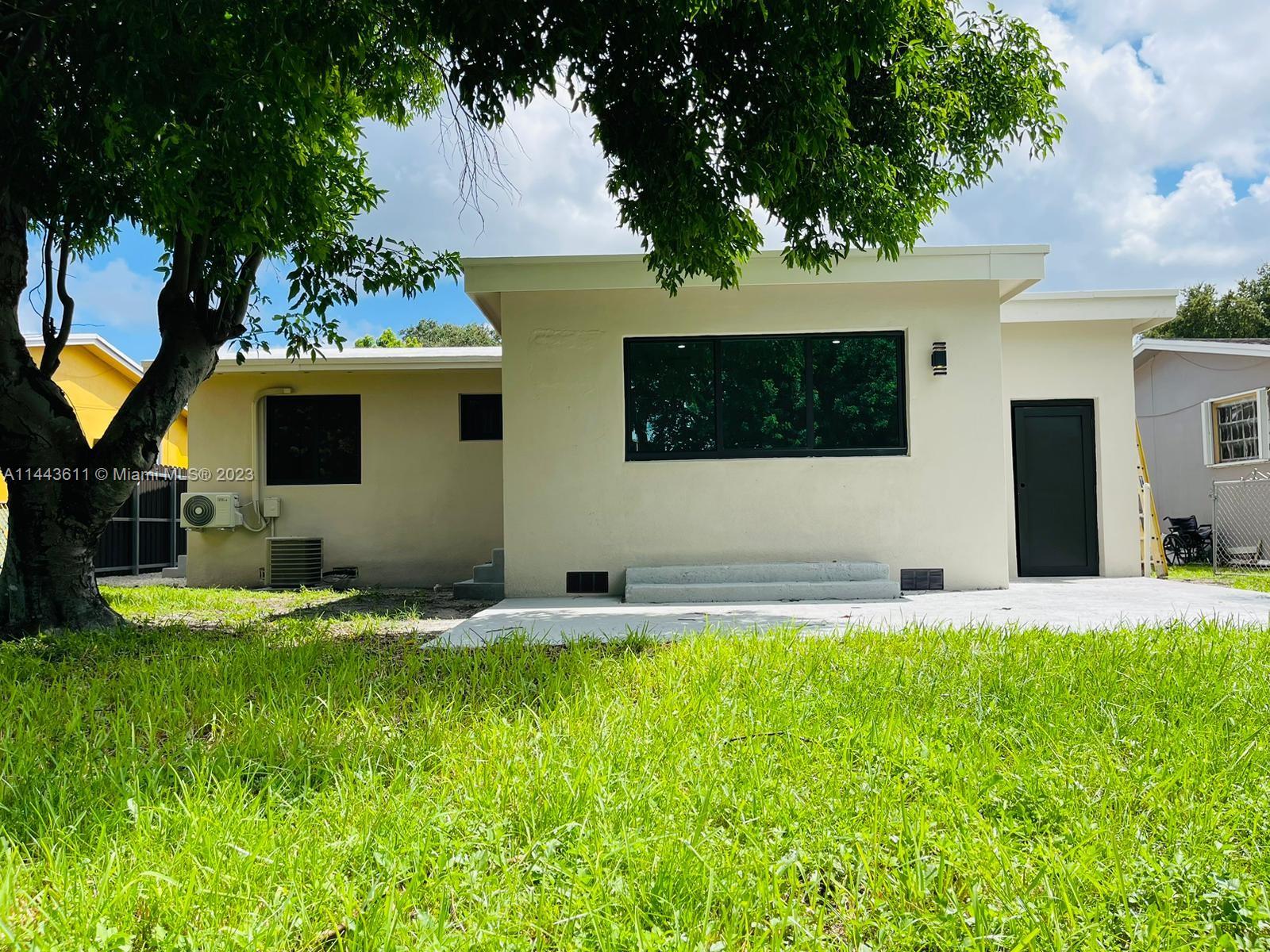 2521 Northwest 121st Street Miami, FL 33167 - Photo 36 of 43 a swimming pool with yard and large trees