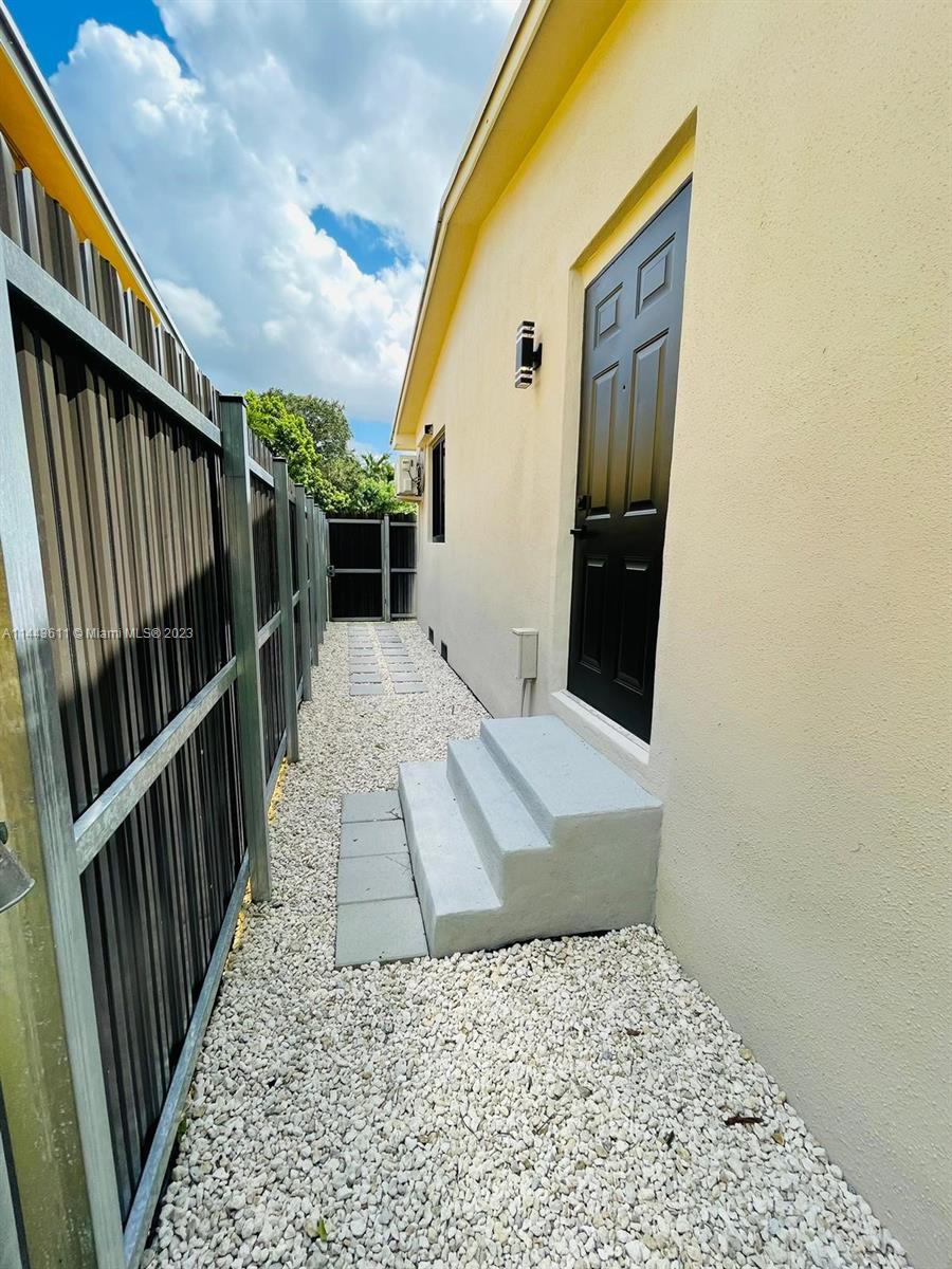 2521 Northwest 121st Street Miami, FL 33167 - Photo 38 of 43 a view of staircase with white walls and railing