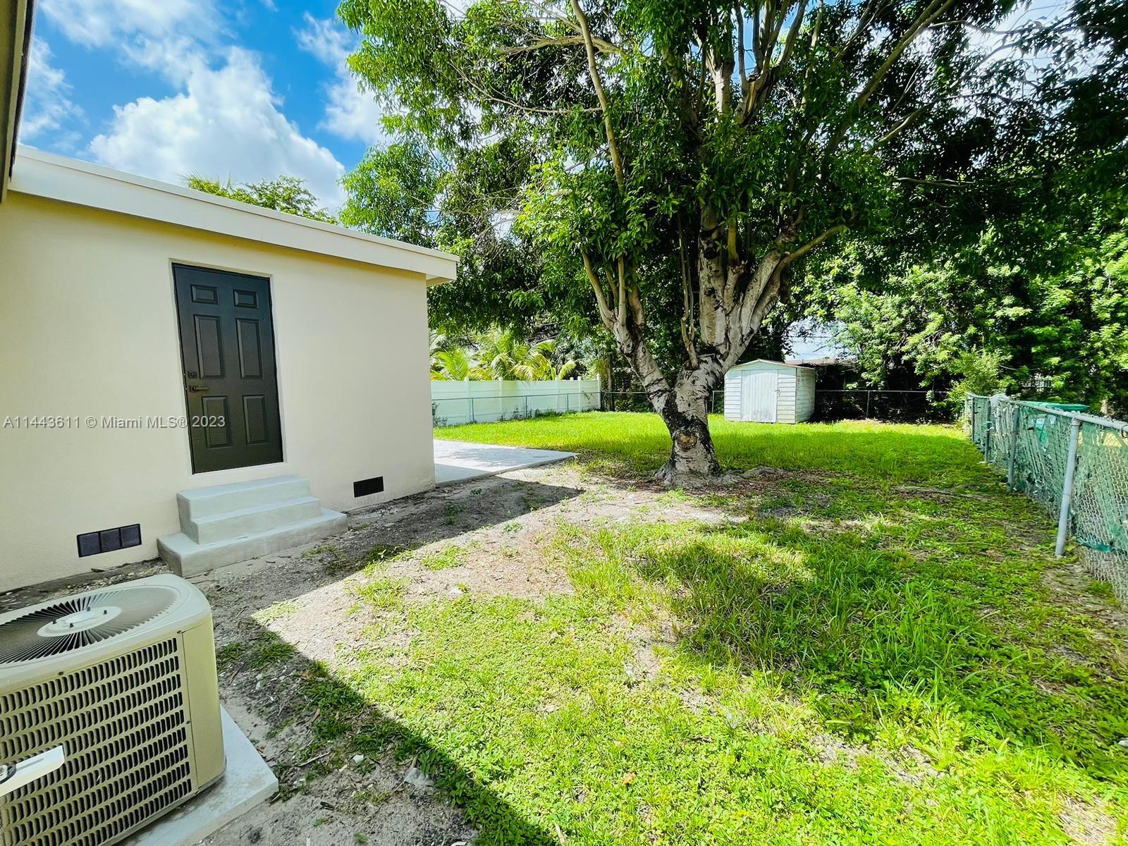 2521 Northwest 121st Street Miami, FL 33167 - Photo 42 of 43 a backyard of a house with barbeque oven