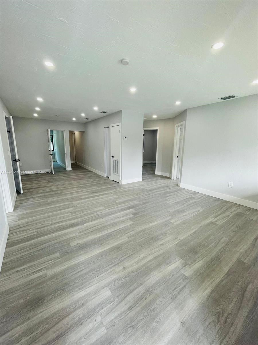 2521 Northwest 121st Street Miami, FL 33167 - Photo 9 of 43 a view of an empty room with wooden floor