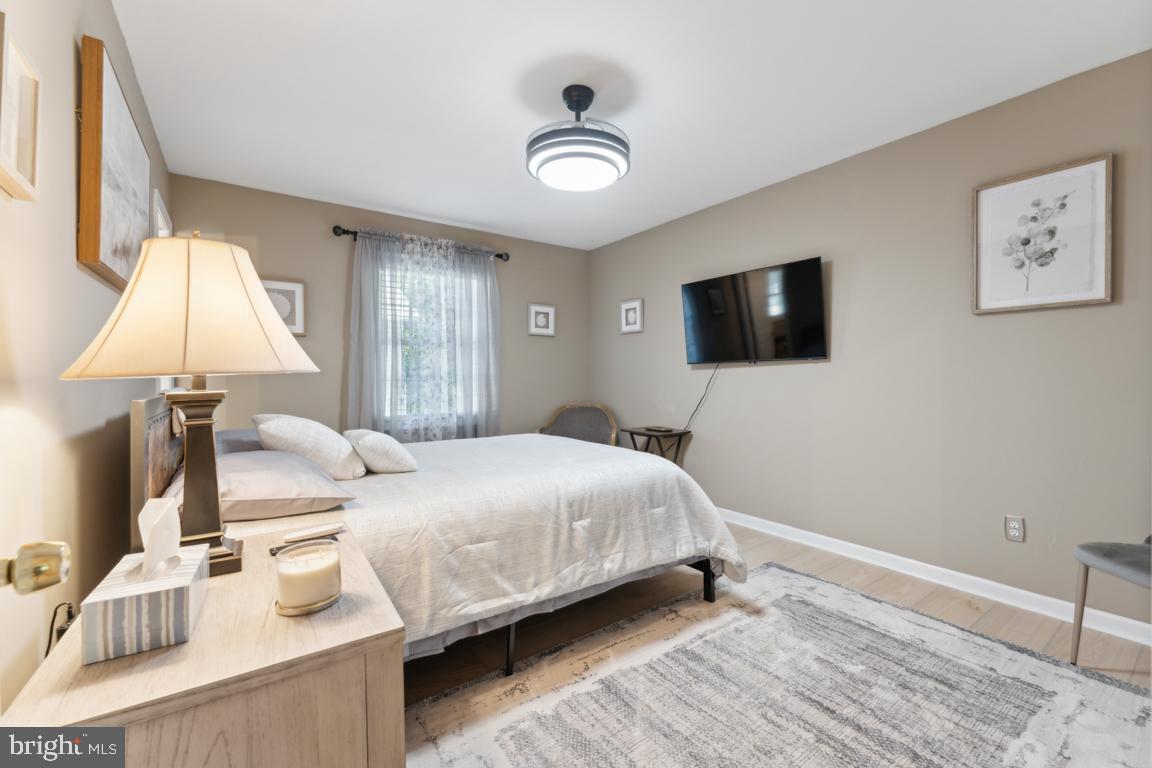 340 A 12th Street Colonial Beach, VA 22443 - Photo 19 of 29 a bedroom with a bed and a flat screen tv