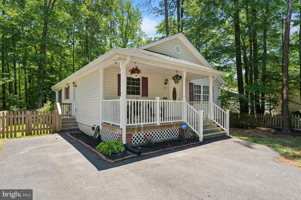 340 A 12th Street Colonial Beach, VA 22443 - Photo 2 of 29 a view of a house with a yard and large trees