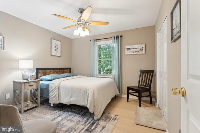 a bedroom with a bed chairs and window