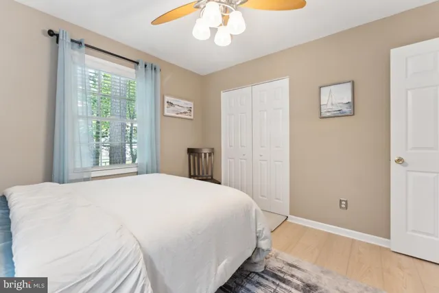 a bedroom with a large bed and a window