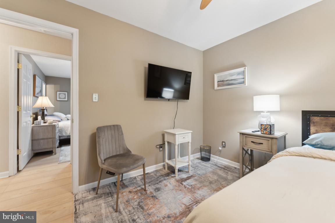 340 A 12th Street Colonial Beach, VA 22443 - Photo 26 of 29 a bedroom with a bed a rug and a flat screen tv