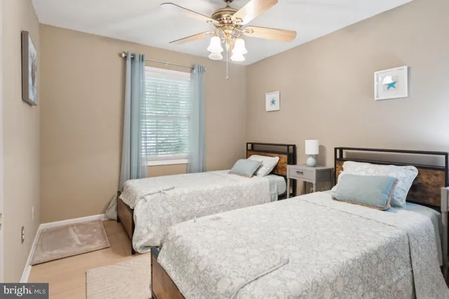 a bedroom with two beds and a chandelier