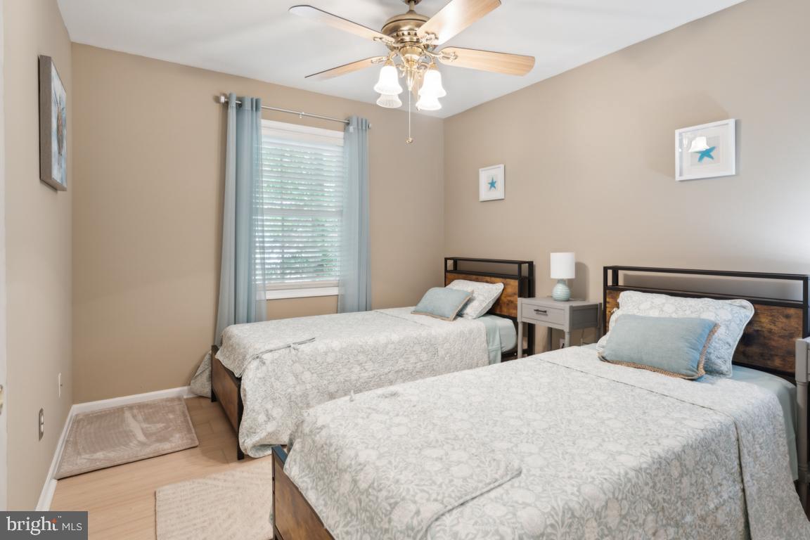 340 A 12th Street Colonial Beach, VA 22443 - Photo 27 of 29 a bedroom with two beds and a chandelier