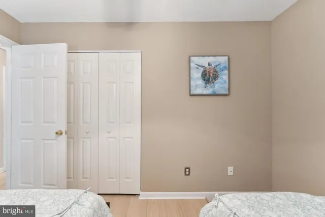 a view of a bedroom with wooden floor