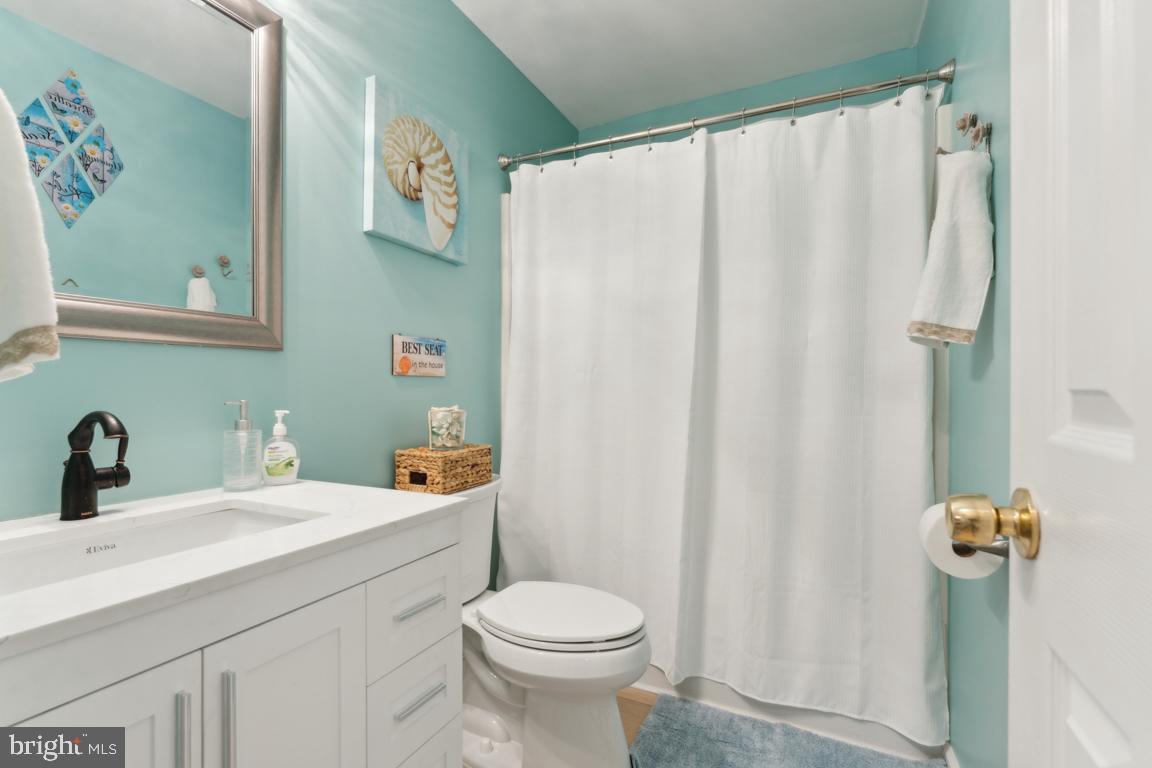 340 A 12th Street Colonial Beach, VA 22443 - Photo 29 of 29 a bathroom with a sink a toilet and shower curtain