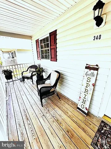 a balcony with wooden floor and furniture