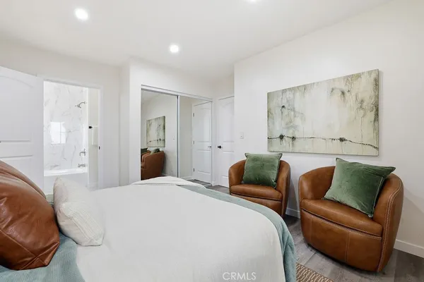 a bedroom with a bed and couch