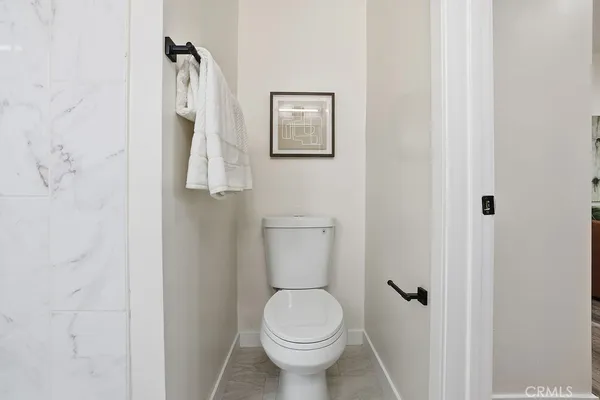 a white toilet sitting next to a bathroom sink