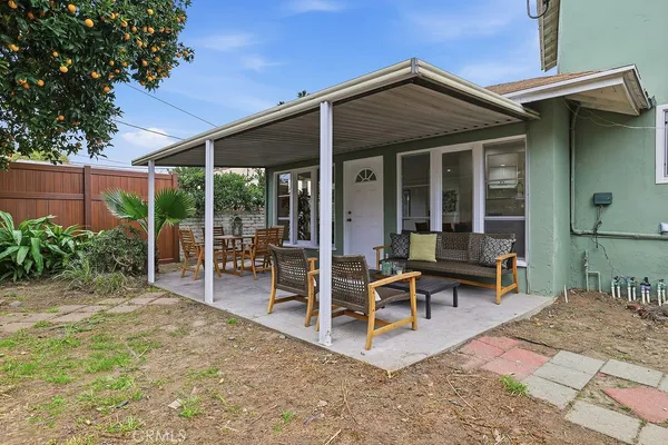 a view of a house with backyard porch and sitting area