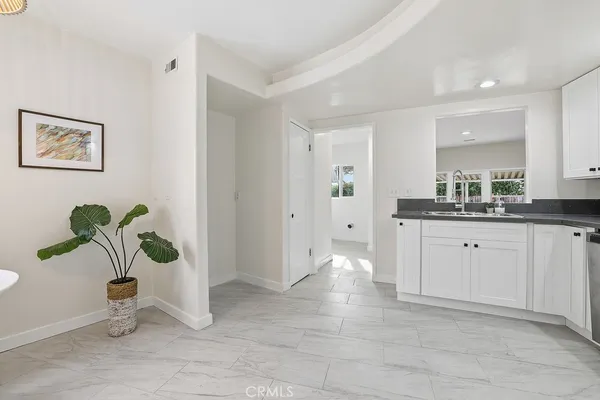 a spacious bathroom with a granite countertop sink and a mirror