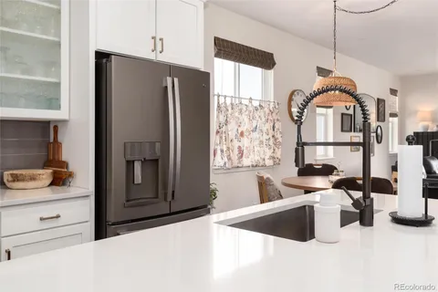 a kitchen with a refrigerator and a sink
