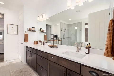 a bathroom with a sink double vanity and a mirror