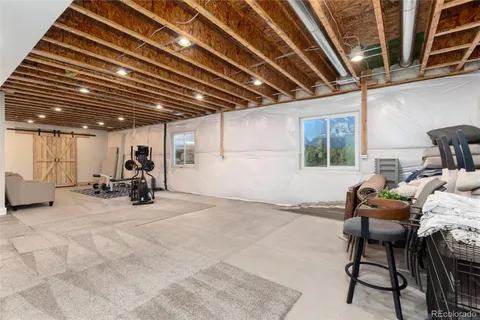 a view of a room with gym equipment and a water heater