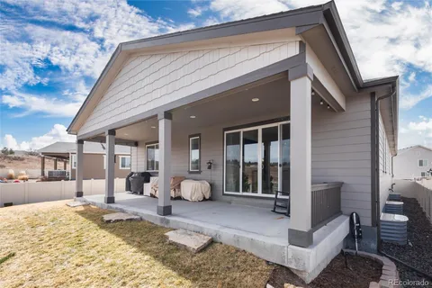 a view of a house with backyard porch and sitting area