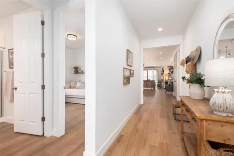 a view of a hallway with wooden floor windows and a livingroom