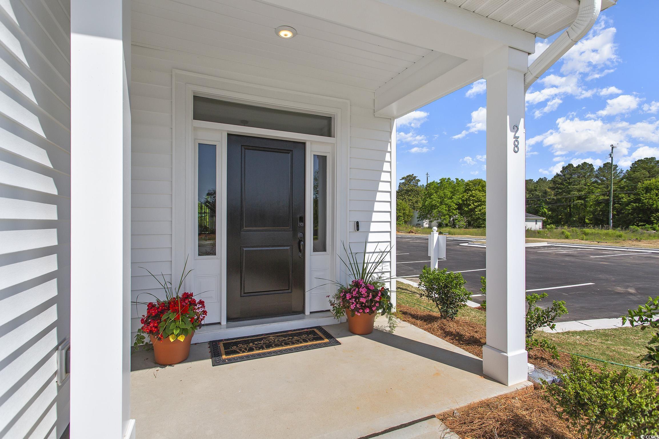 760 Enchantment Loop Myrtle Beach, SC 29588 - Photo 2 of 10 View of exterior entry featuring covered porch