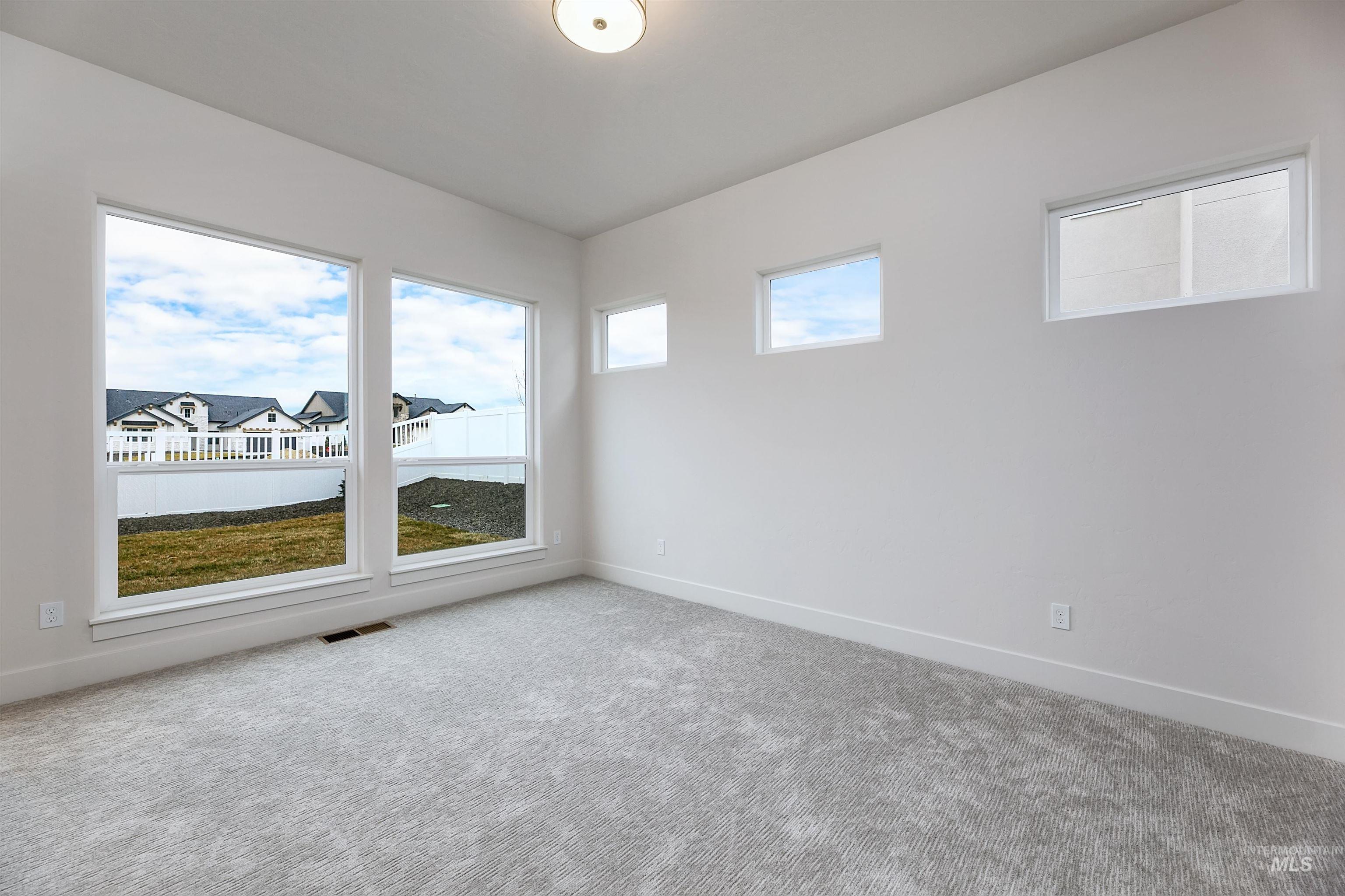 13331 North Spring Creek Way Boise, ID 83714 - Photo 13 of 43 Empty room featuring carpet flooring and baseboards