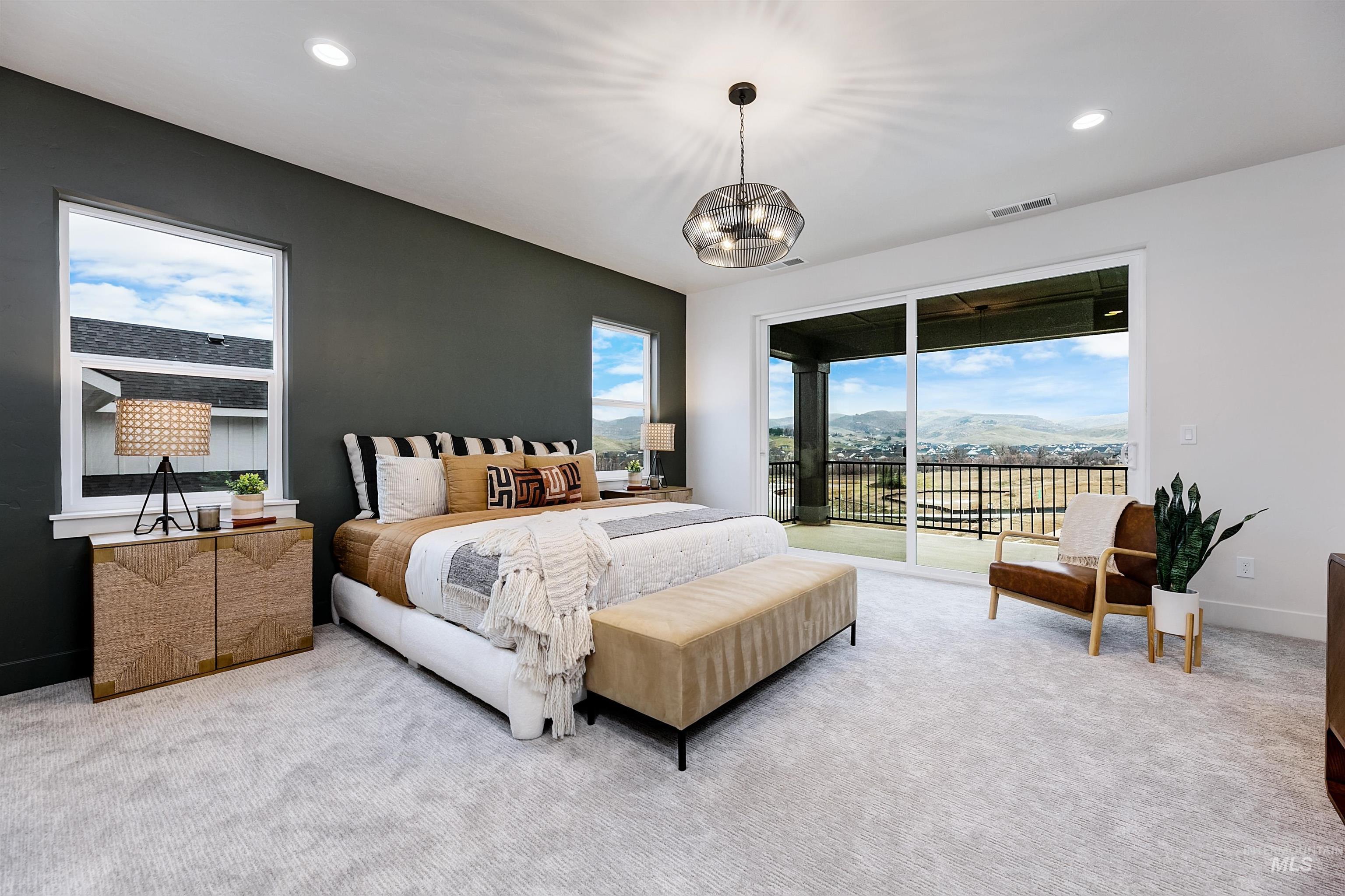 13331 North Spring Creek Way Boise, ID 83714 - Photo 21 of 43 Carpeted bedroom featuring a mountain view, access to exterior, and suspended lighting