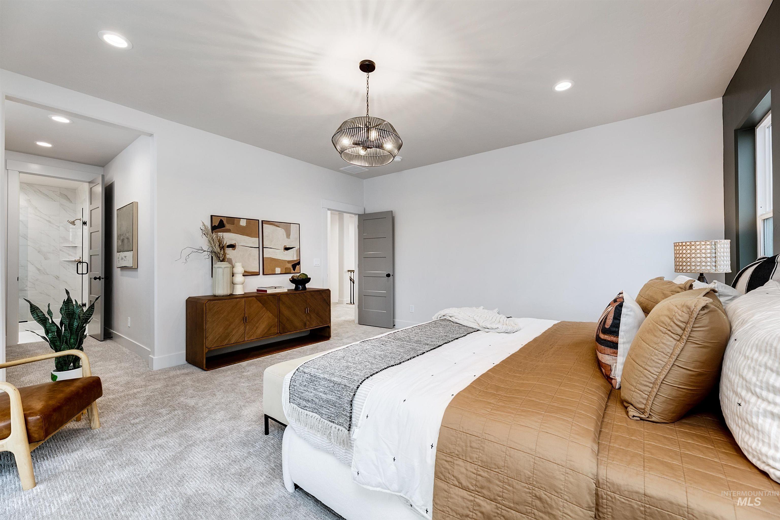 13331 North Spring Creek Way Boise, ID 83714 - Photo 22 of 43 Carpeted bedroom featuring hanging lights and ensuite bathroom