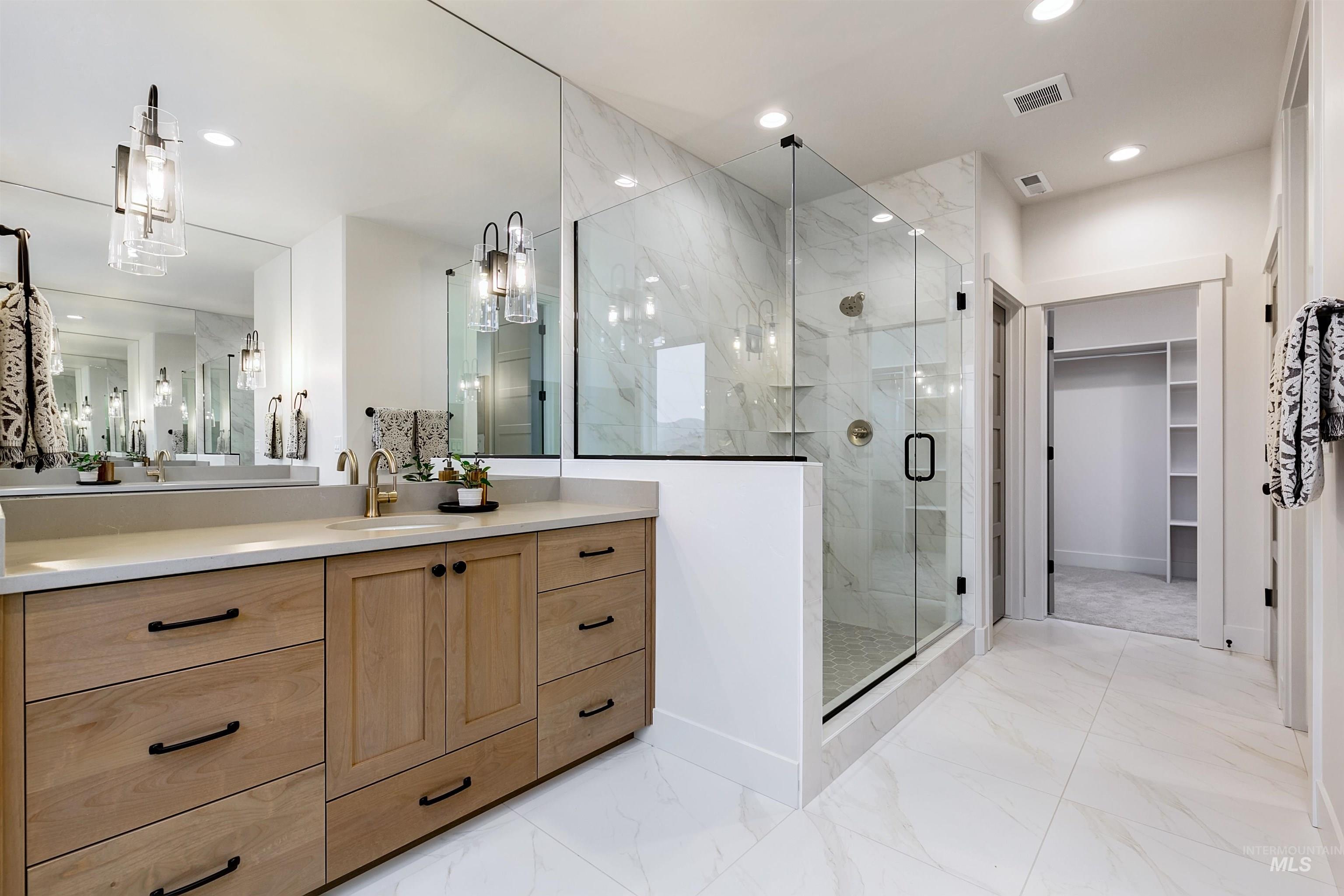 13331 North Spring Creek Way Boise, ID 83714 - Photo 25 of 43 Bathroom with a spacious closet, a marble finish shower, vanity, light marble finish flooring, and recessed lighting