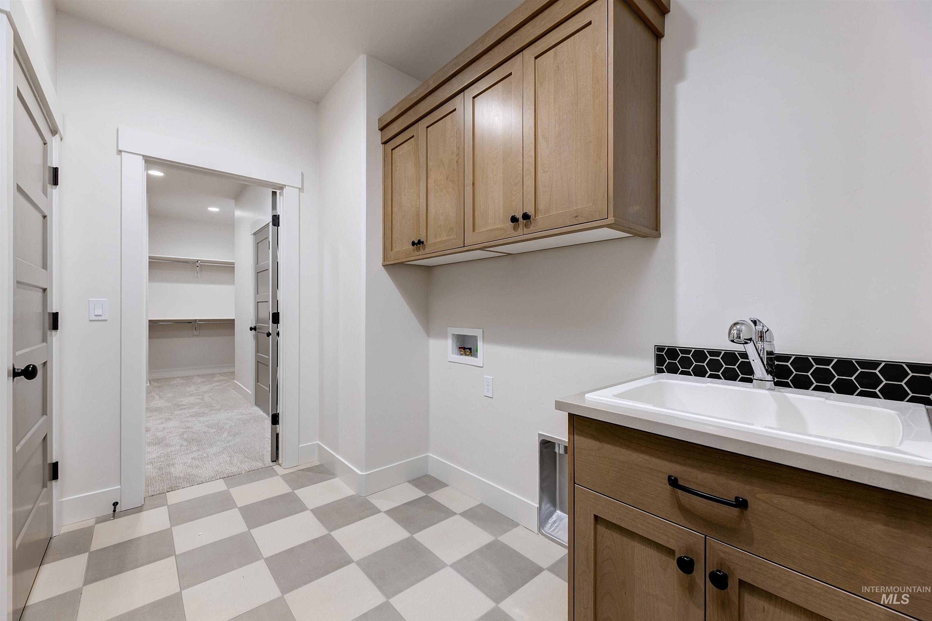 13331 North Spring Creek Way Boise, ID 83714 - Photo 27 of 43 Laundry room featuring light flooring, hookup for a washing machine, and cabinet space