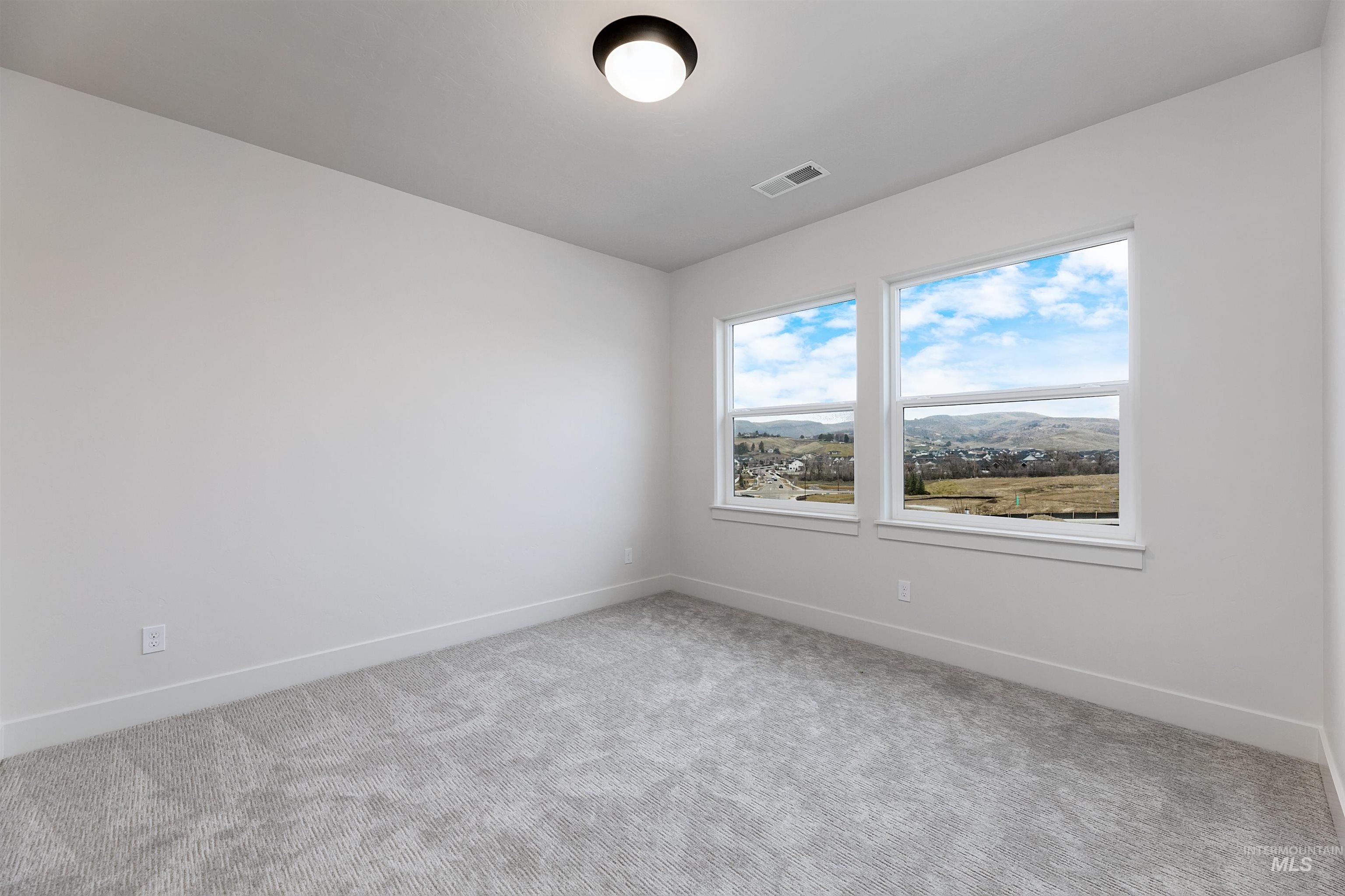 13331 North Spring Creek Way Boise, ID 83714 - Photo 28 of 43 Carpeted spare room with baseboards
