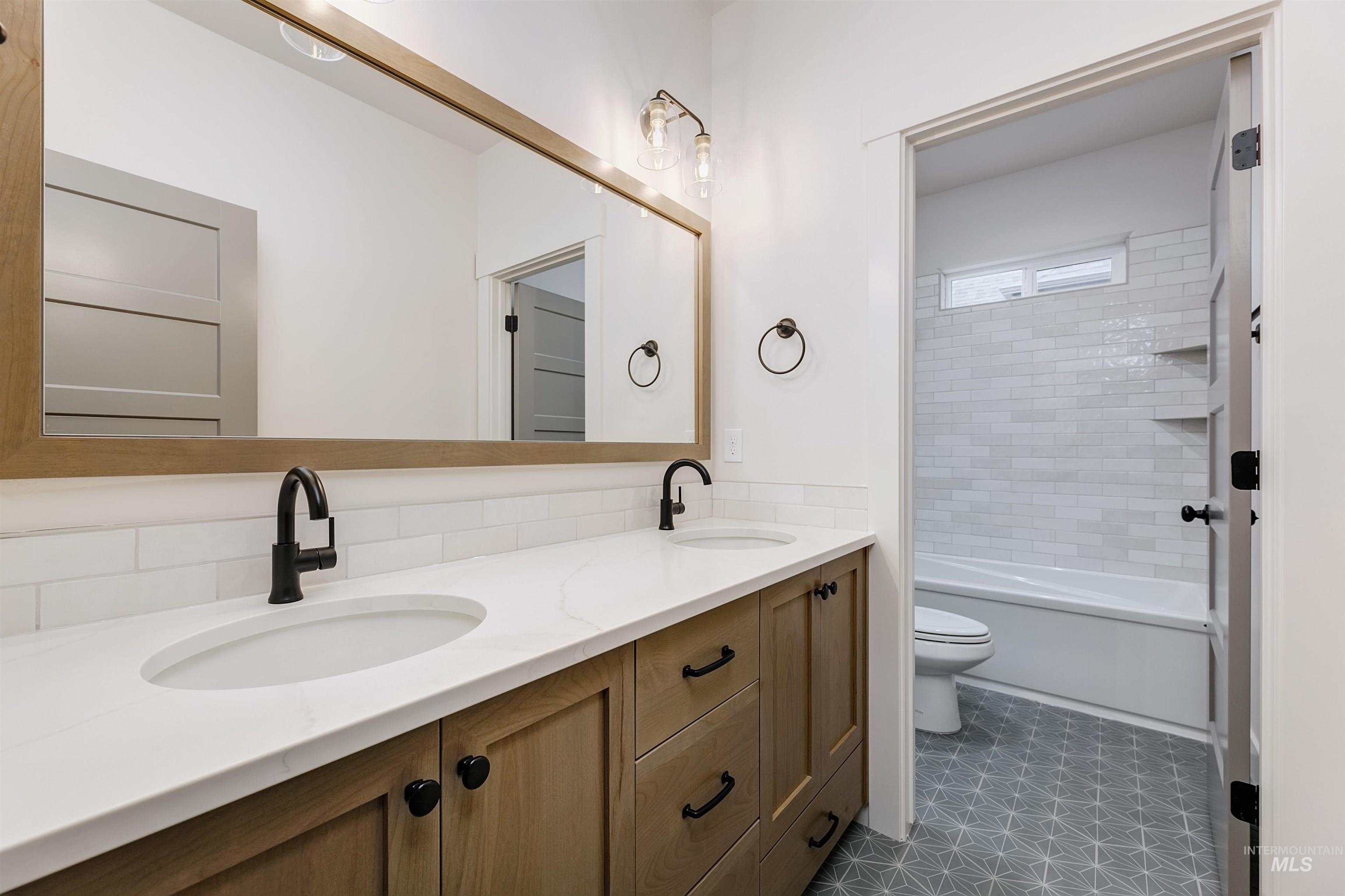 13331 North Spring Creek Way Boise, ID 83714 - Photo 29 of 43 Bathroom with double vanity and washtub / shower combination