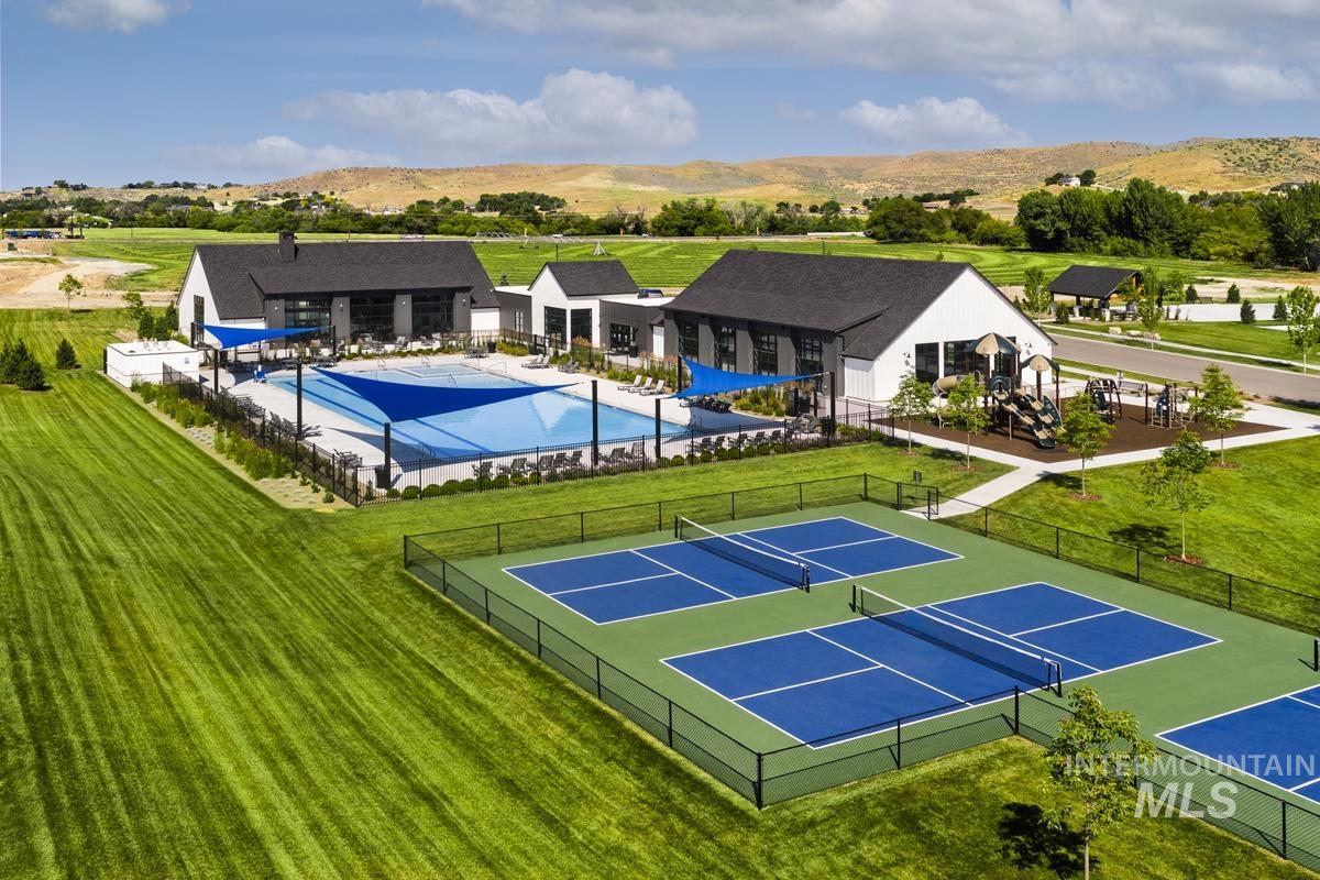 13331 North Spring Creek Way Boise, ID 83714 - Photo 31 of 43 View of tennis court featuring a mountain view, a patio, and a community pool