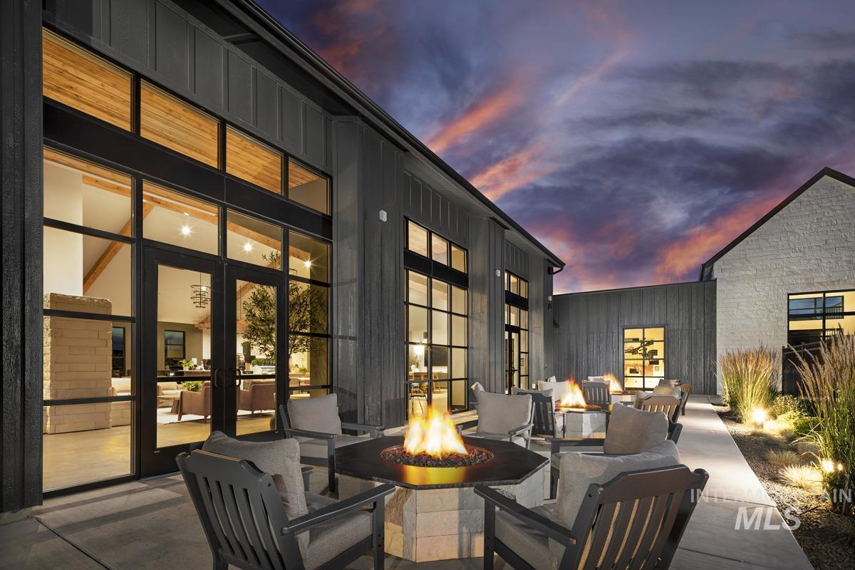 13331 North Spring Creek Way Boise, ID 83714 - Photo 39 of 43 Patio terrace at dusk featuring a patio, an outdoor fire pit, and french doors