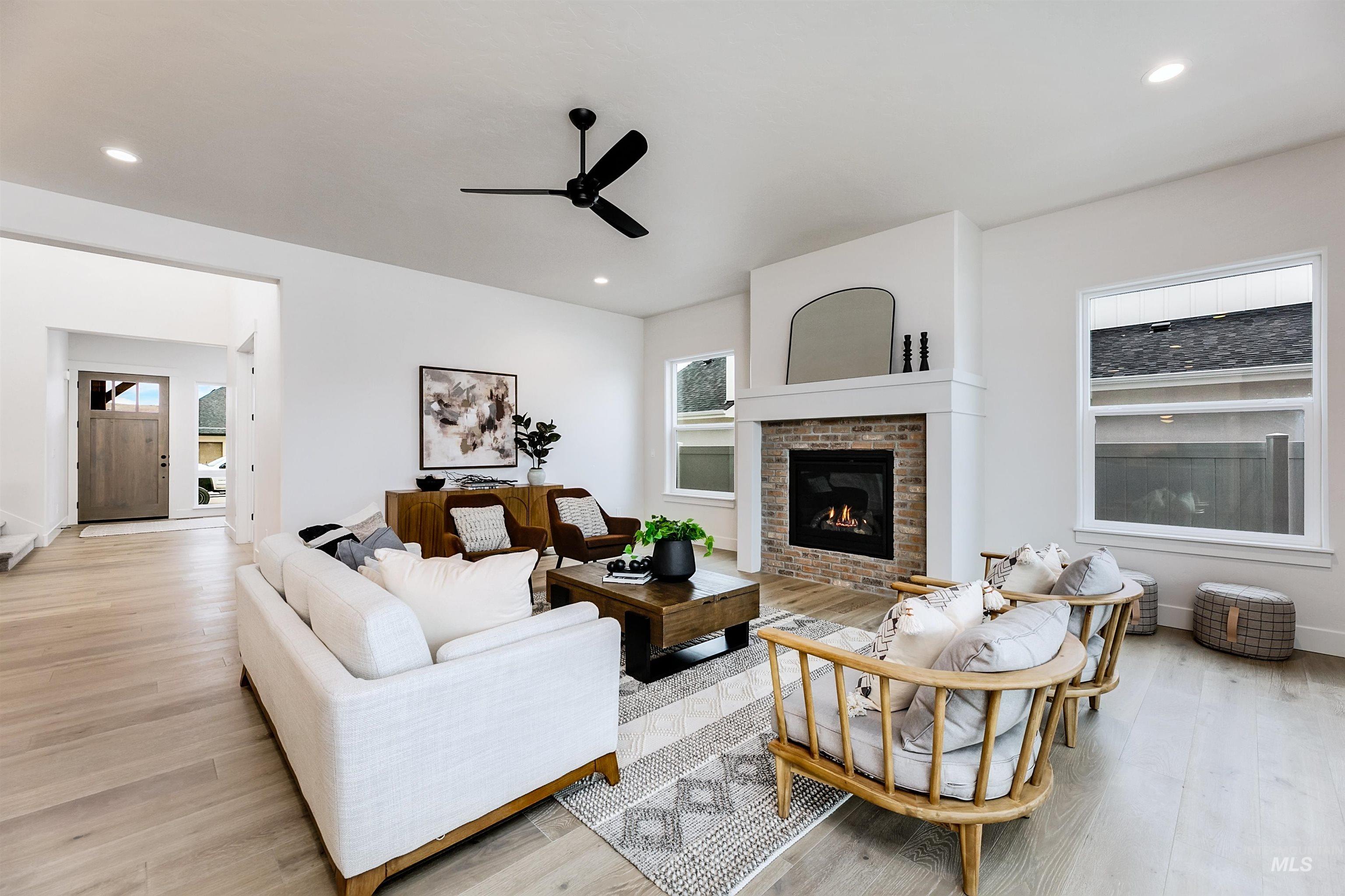 13331 North Spring Creek Way Boise, ID 83714 - Photo 5 of 43 Living area featuring a ceiling fan, light wood-style flooring, a fireplace, and recessed lighting