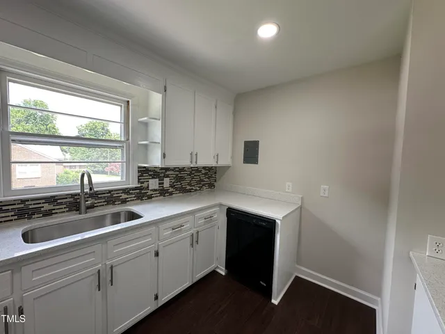 a kitchen with a sink stove and cabinets