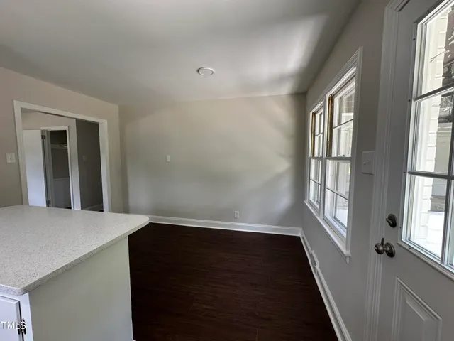 a kitchen with wooden floors and white appliances
