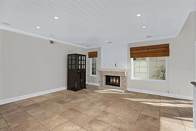 a kitchen with stainless steel appliances kitchen island granite countertop a refrigerator and cabinets