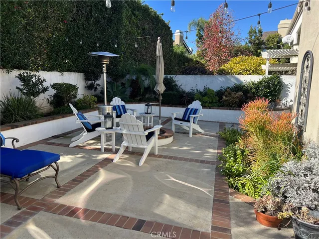 a view of swimming pool with outdoor seating and plants