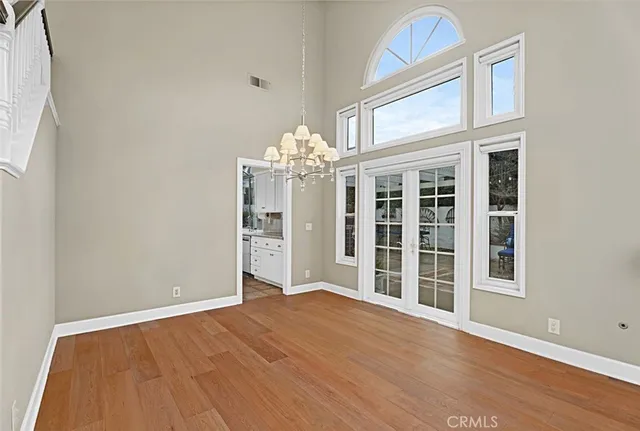 an empty room with windows and fireplace