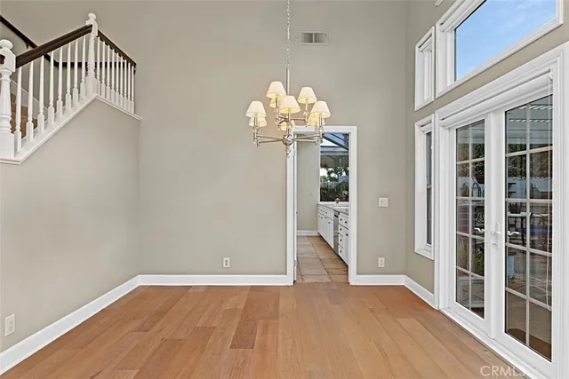 a view of an empty room with a fireplace and a window
