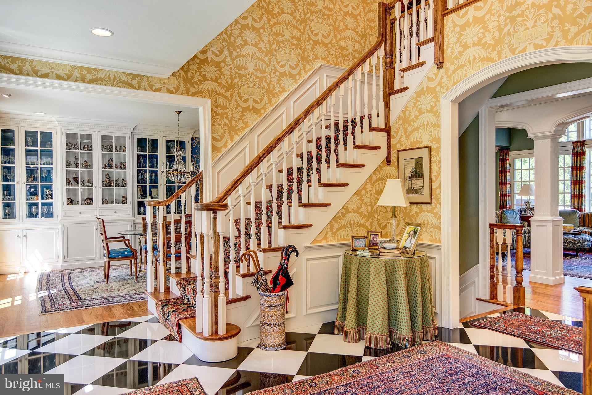 135 Winding Way Haddonfield, NJ 08033 - Photo 12 of 100 a view of a hallway with a black white checkered floor and a rug