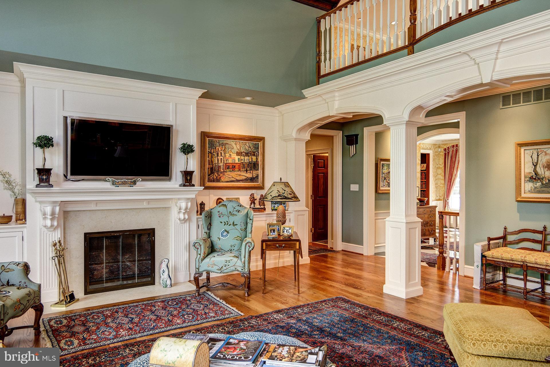 135 Winding Way Haddonfield, NJ 08033 - Photo 23 of 100 a living room with furniture a flat screen tv and a fireplace
