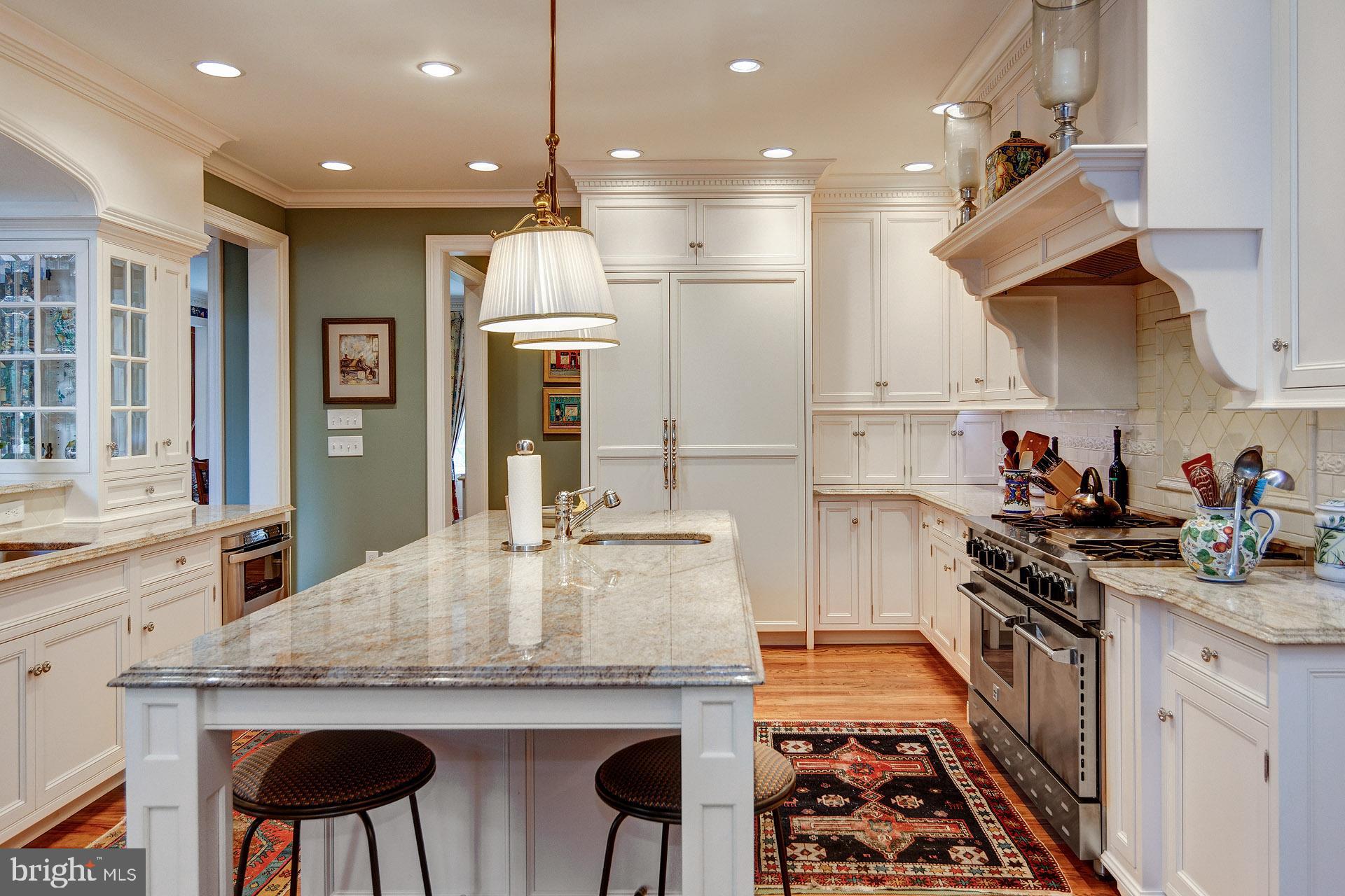 135 Winding Way Haddonfield, NJ 08033 - Photo 33 of 100 a kitchen with kitchen island granite countertop wooden cabinets and a stove