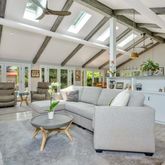 a living room with furniture and a chandelier